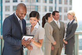 Interracial Men & Women Business Team With Tablet Computer